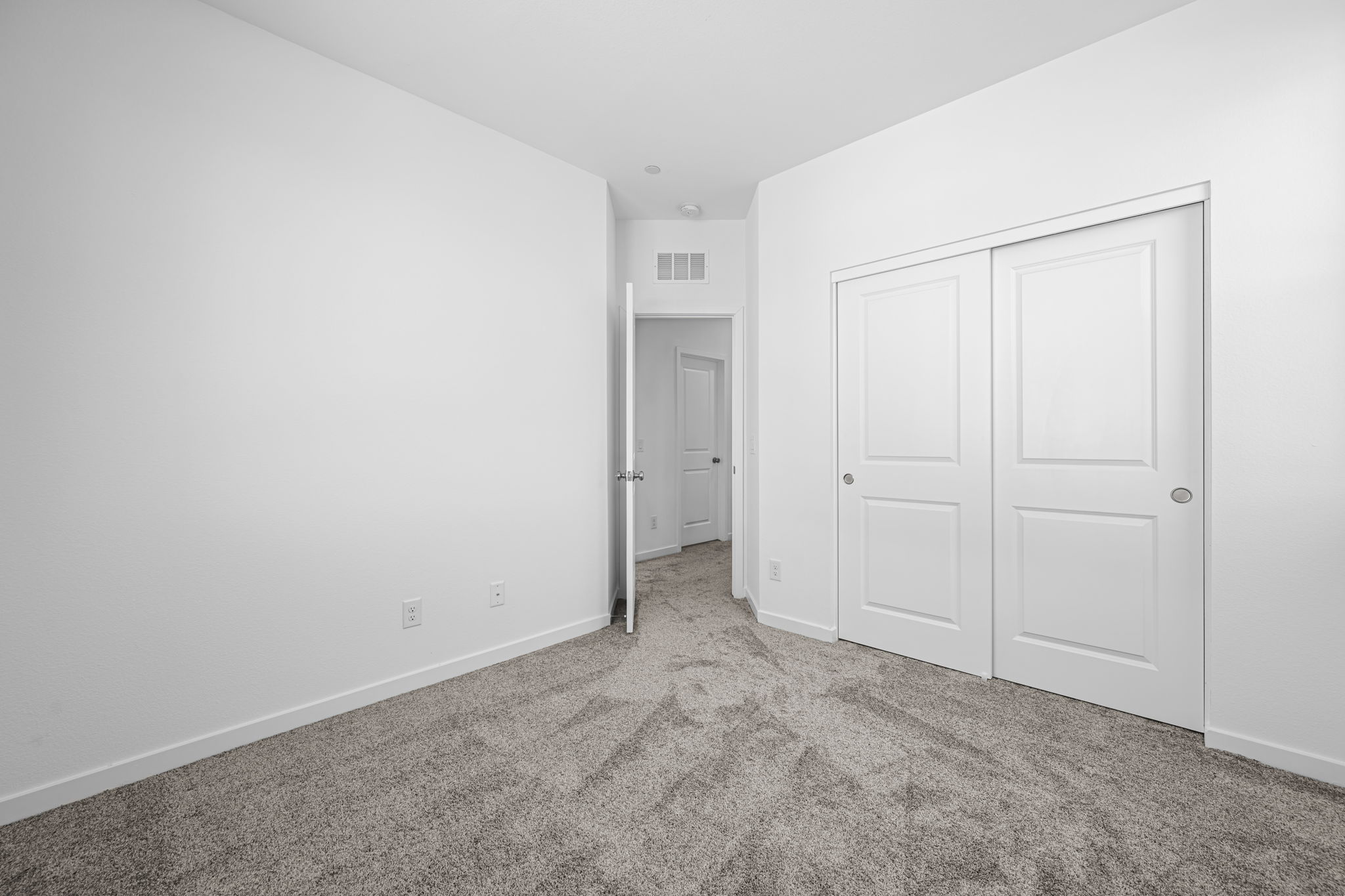 A hallway with white doors.