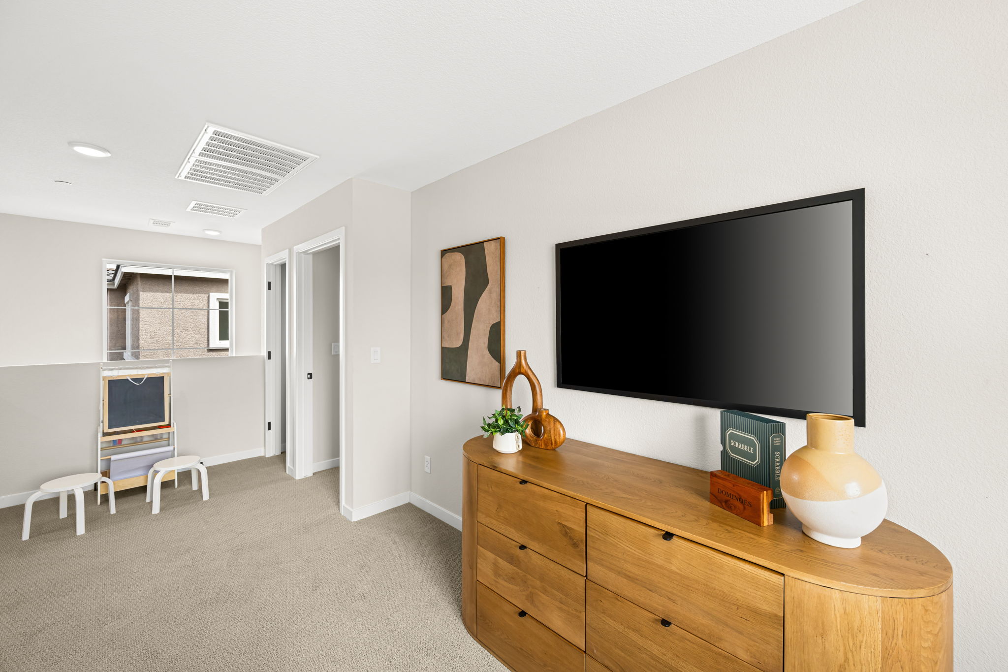 A room with a tv and a table.