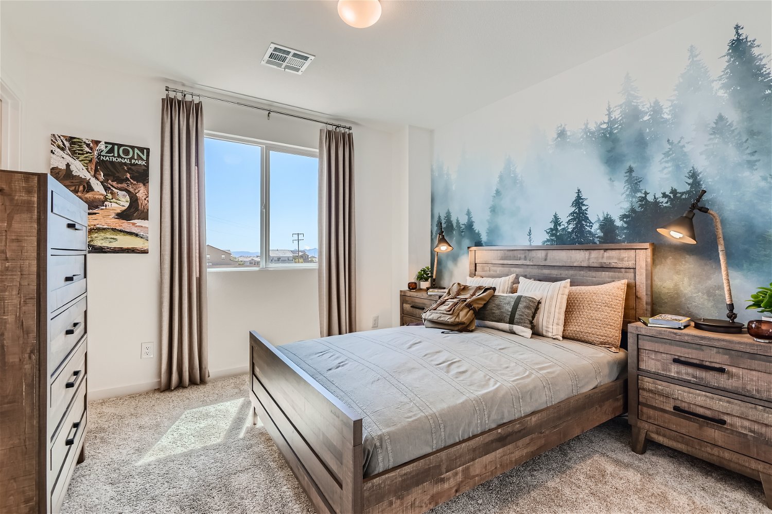 A bedroom with a large window.