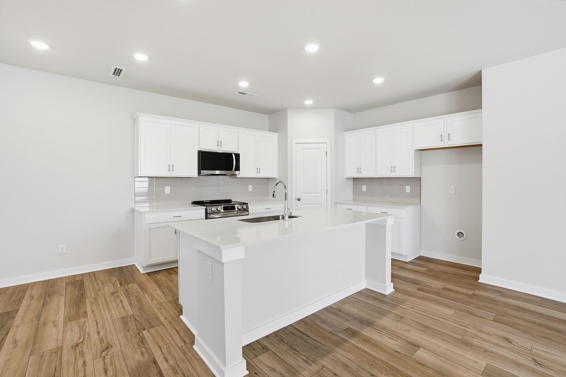 A kitchen with white cabinets.