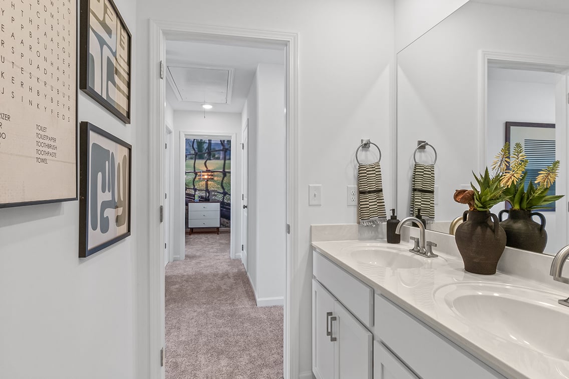 A bathroom with a sink and a mirror.