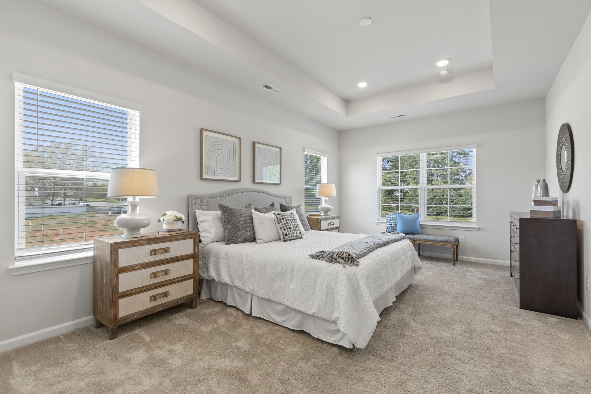 A bedroom with a bed and a chair.