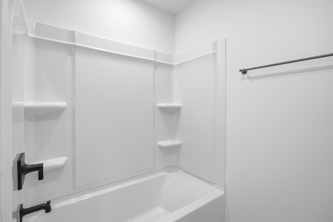 A bathroom with a bathtub and toilet.