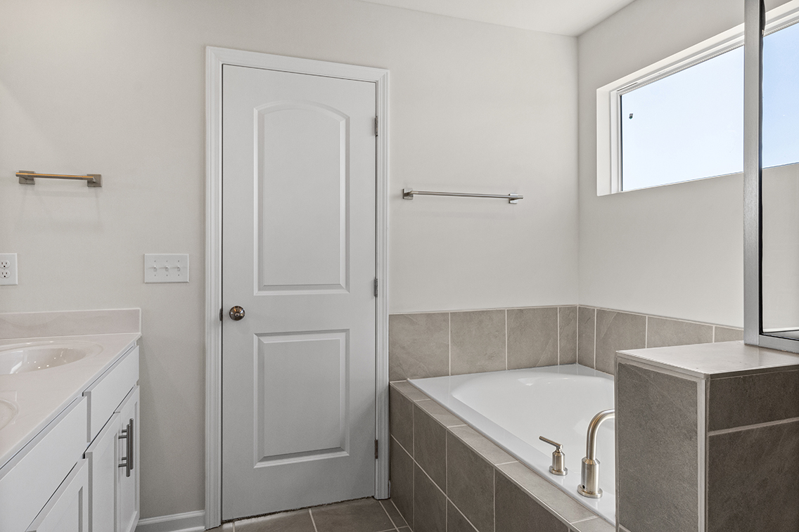 A bathroom with a tub and sink.