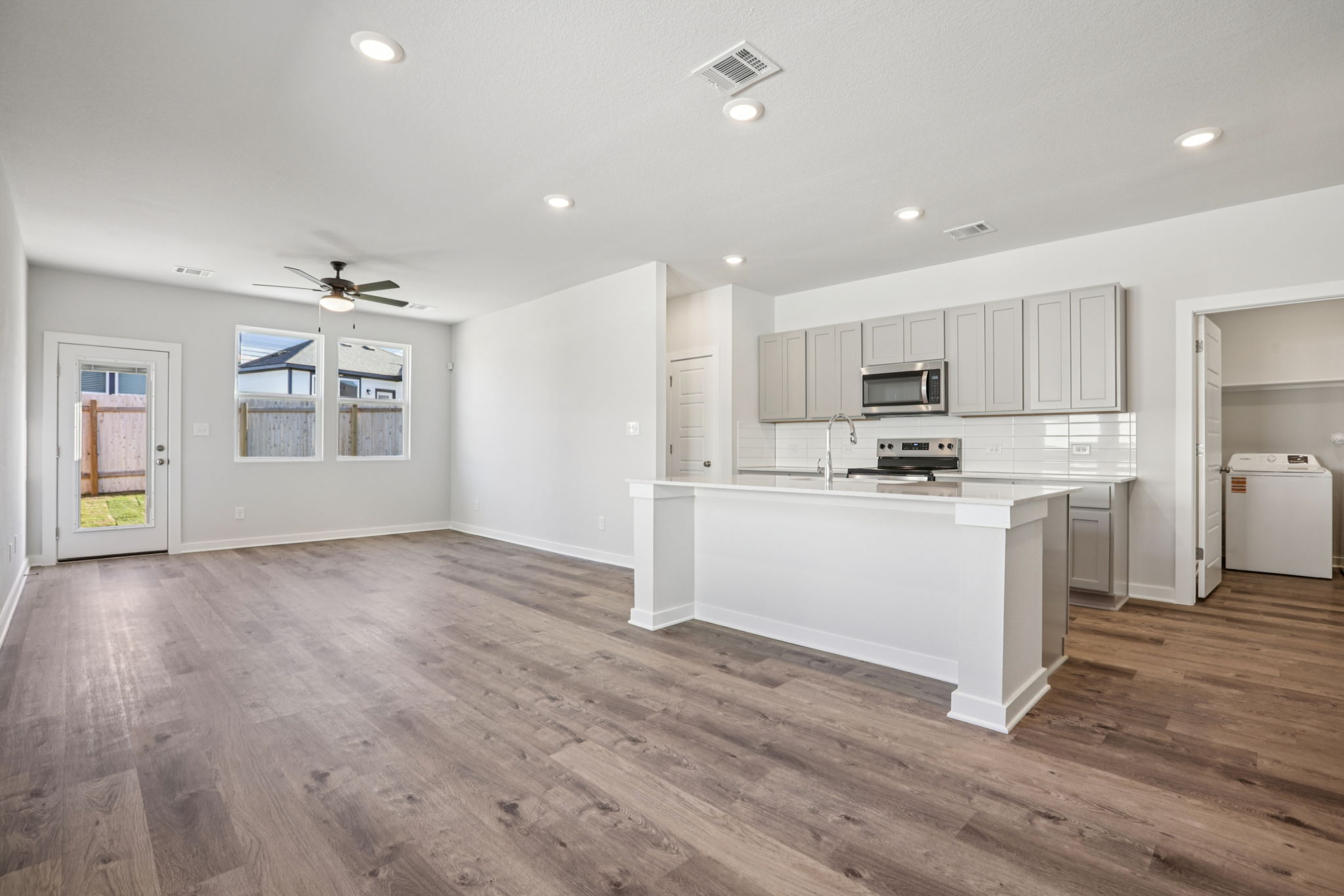A large kitchen with white cabinets.