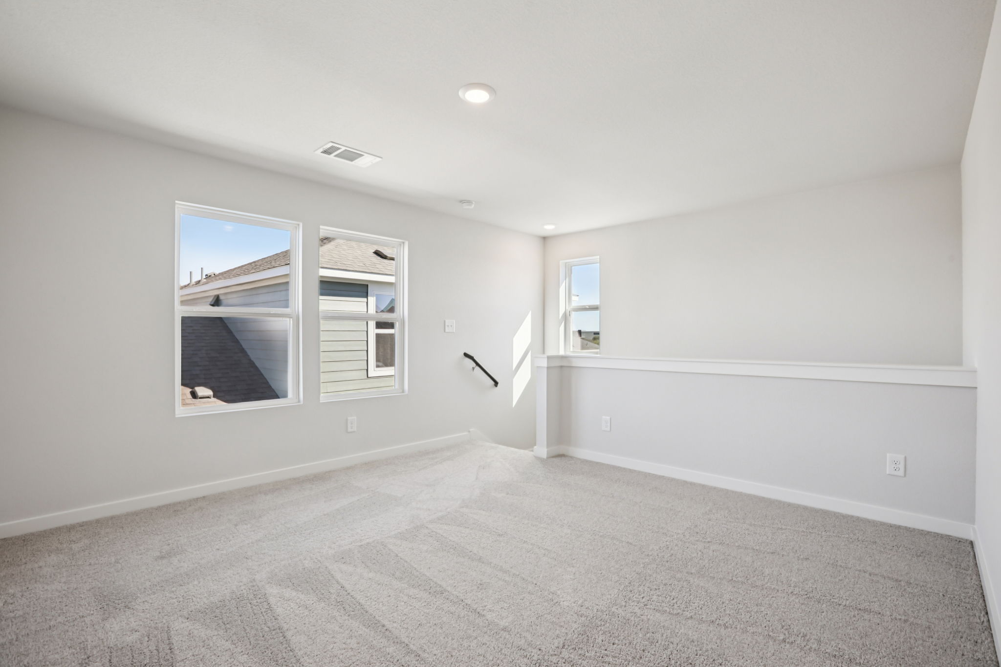 A room with a window and a carpet.