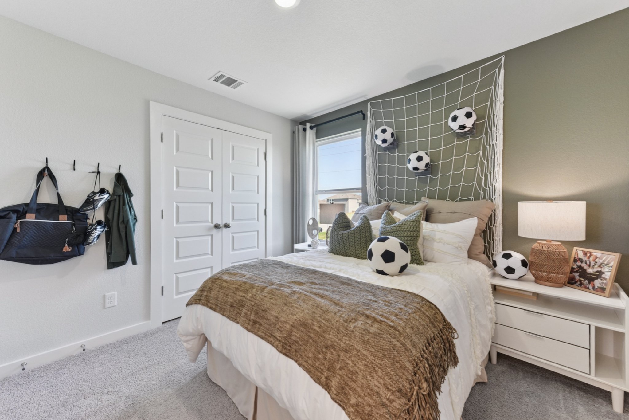 A bedroom with a large mirror.