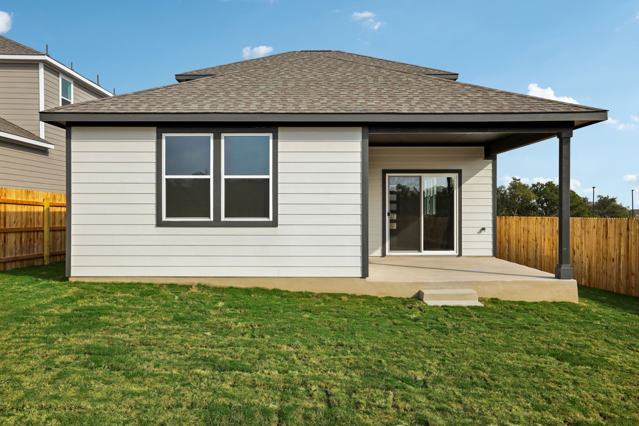 A house with a fence and grass.