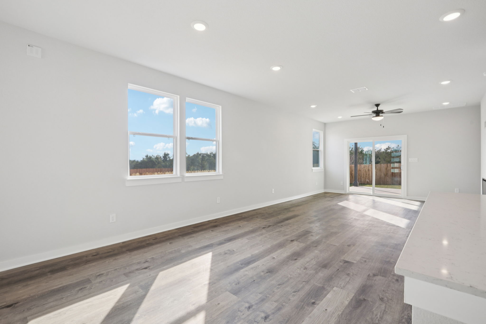 A room with a wood floor and a wood floor with a window and a wood floor with a.