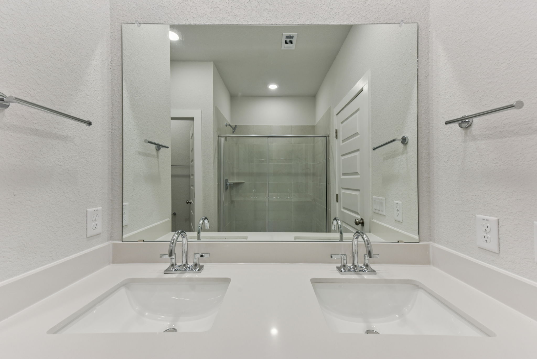 A bathroom with a large mirror.
