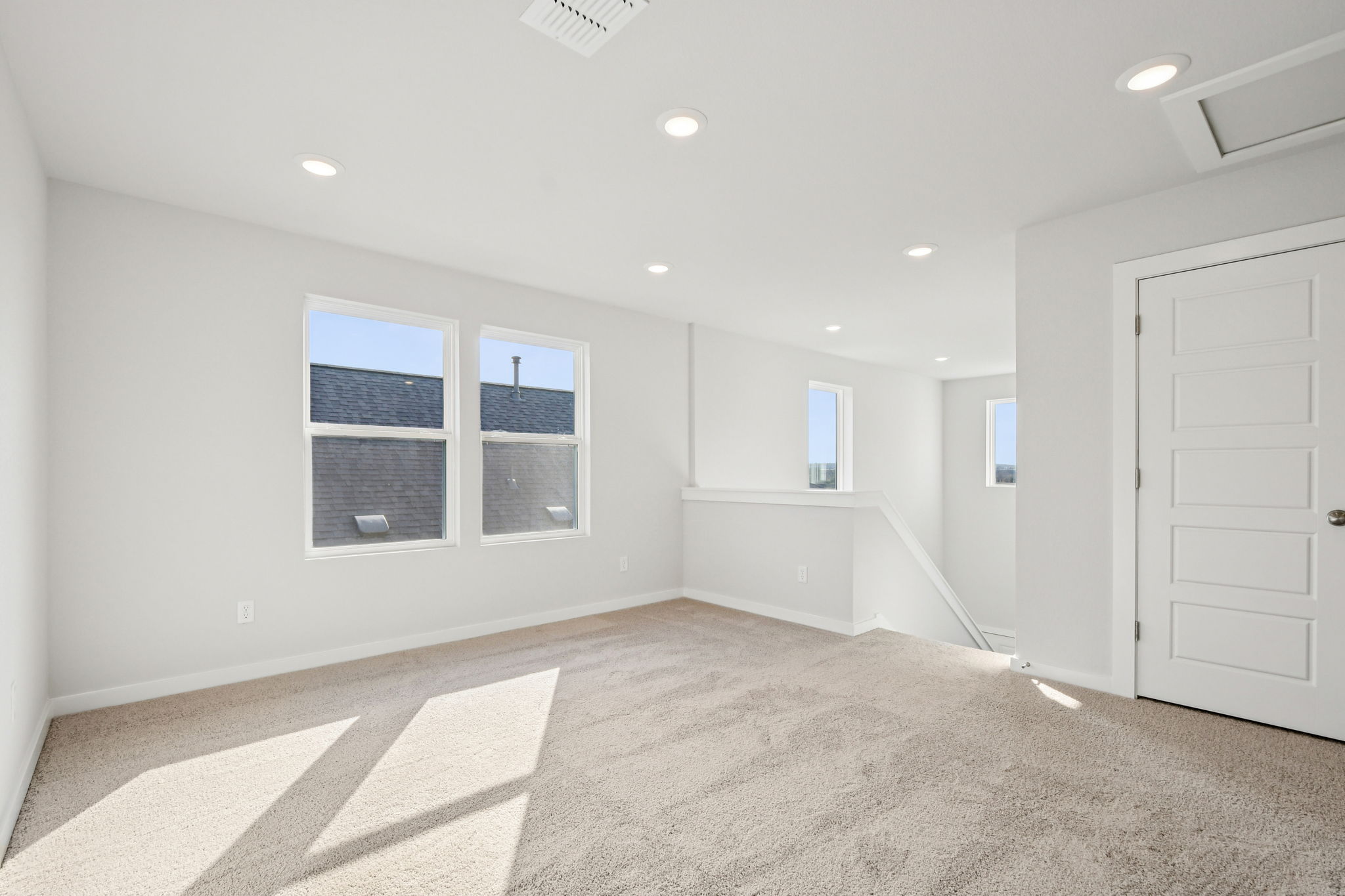 A room with white walls and windows.