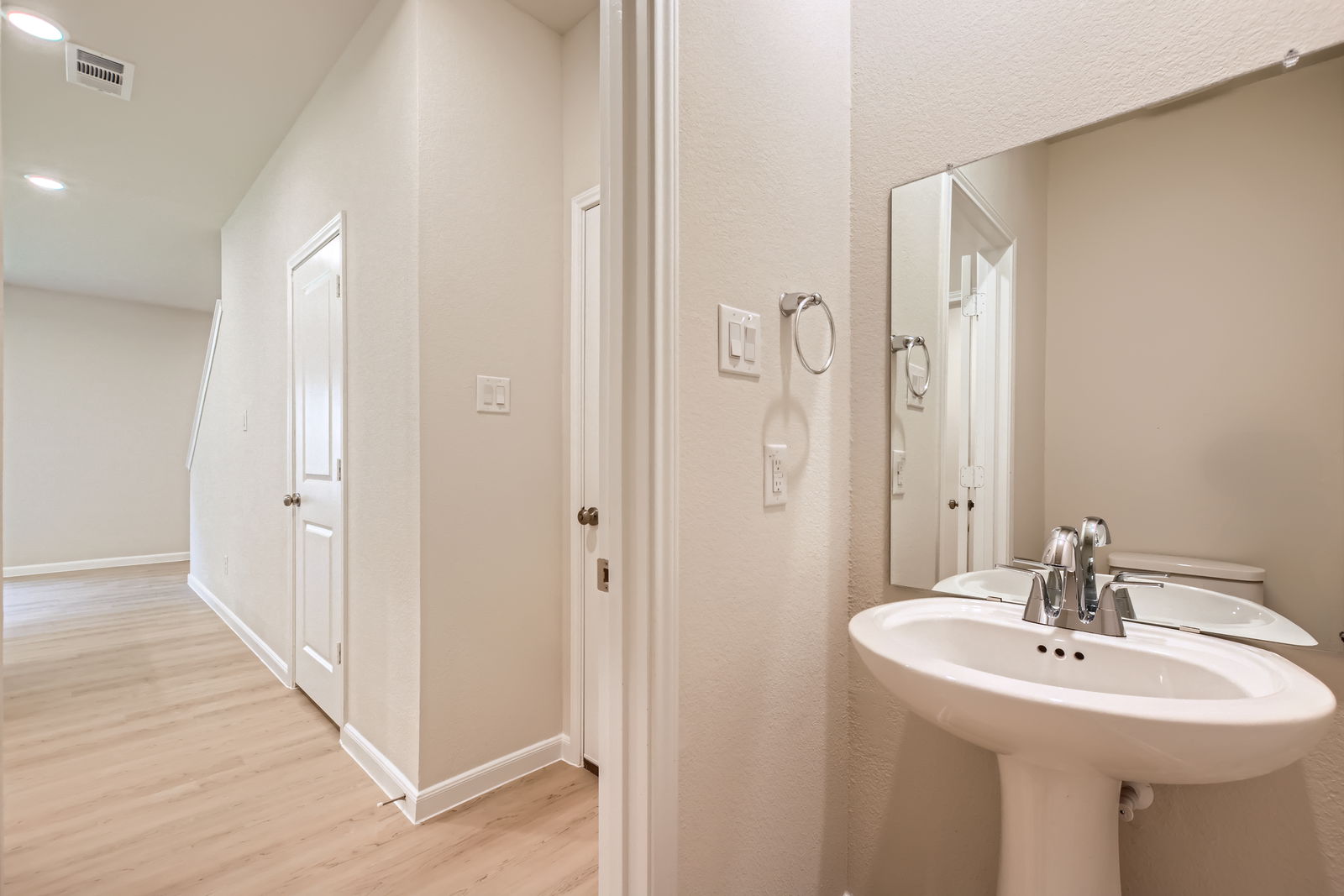 A bathroom with a sink and a mirror.