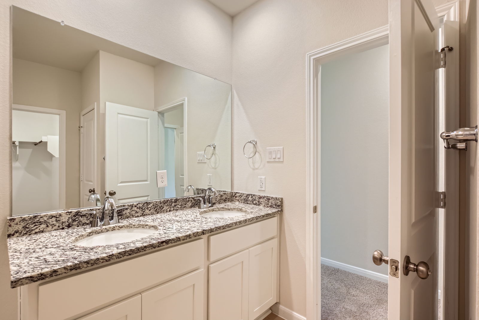 A bathroom with a marble countertop.