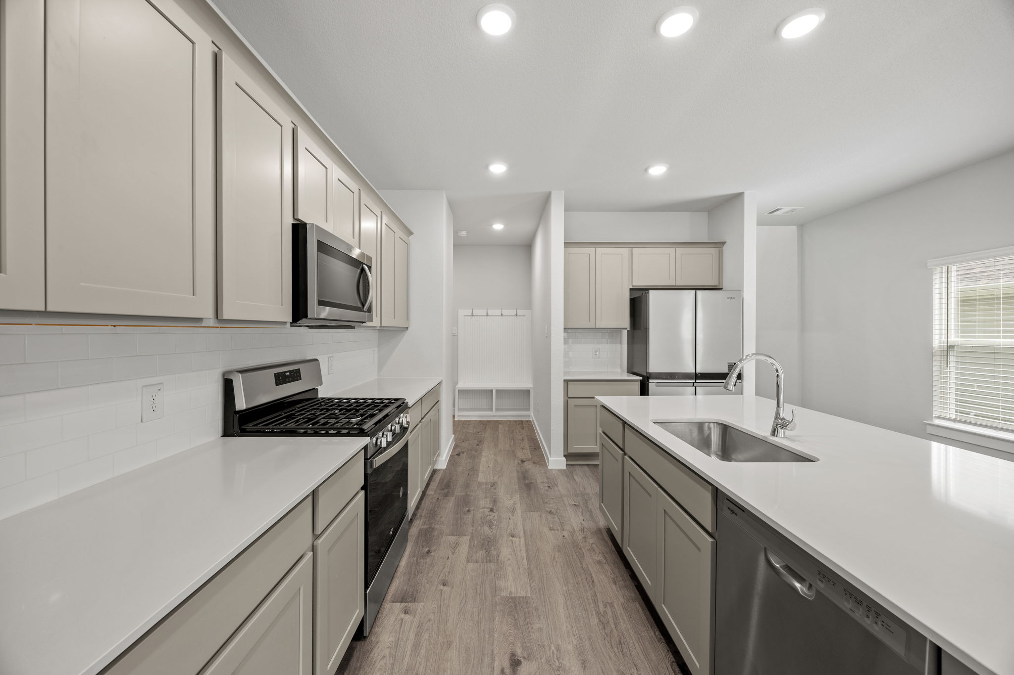 A kitchen with white cabinets.