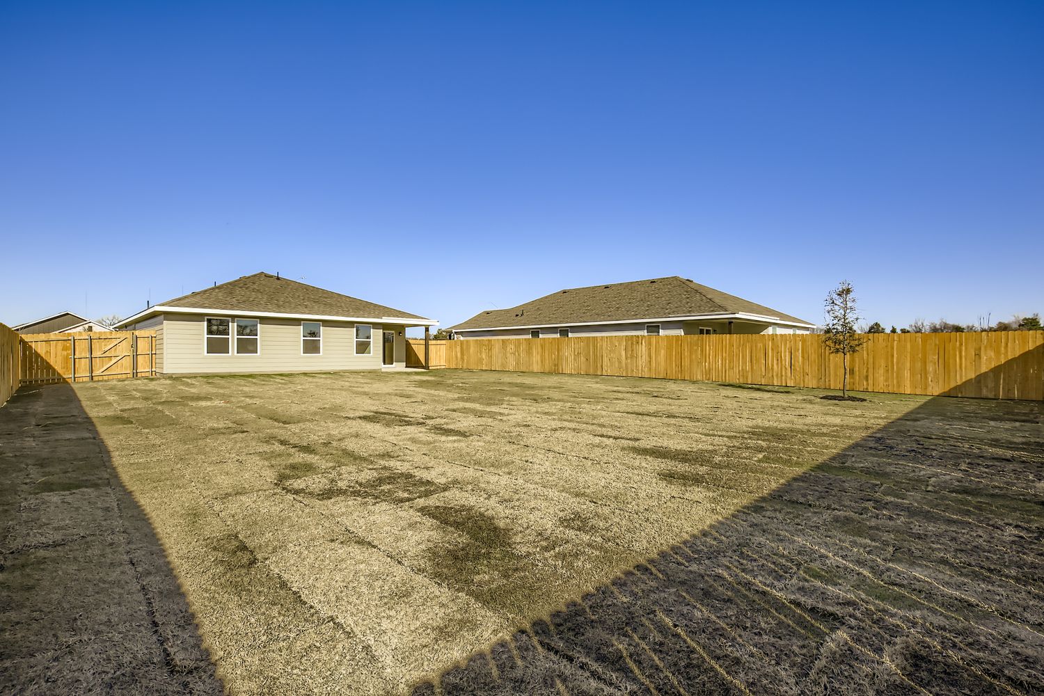 A fenced in dirt field.