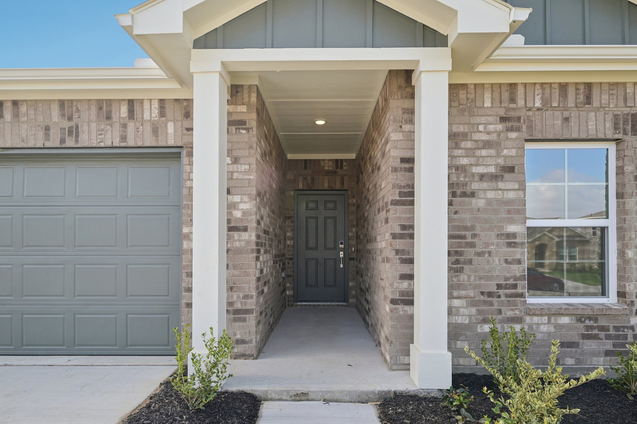 A building with a garage door and a garage door.