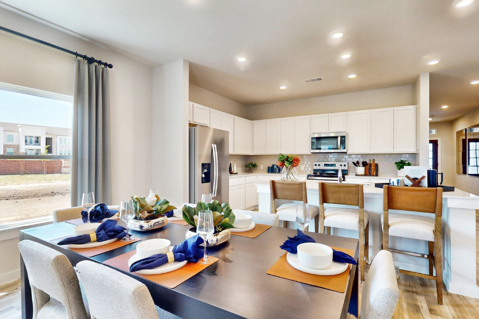 A kitchen with a dining table.
