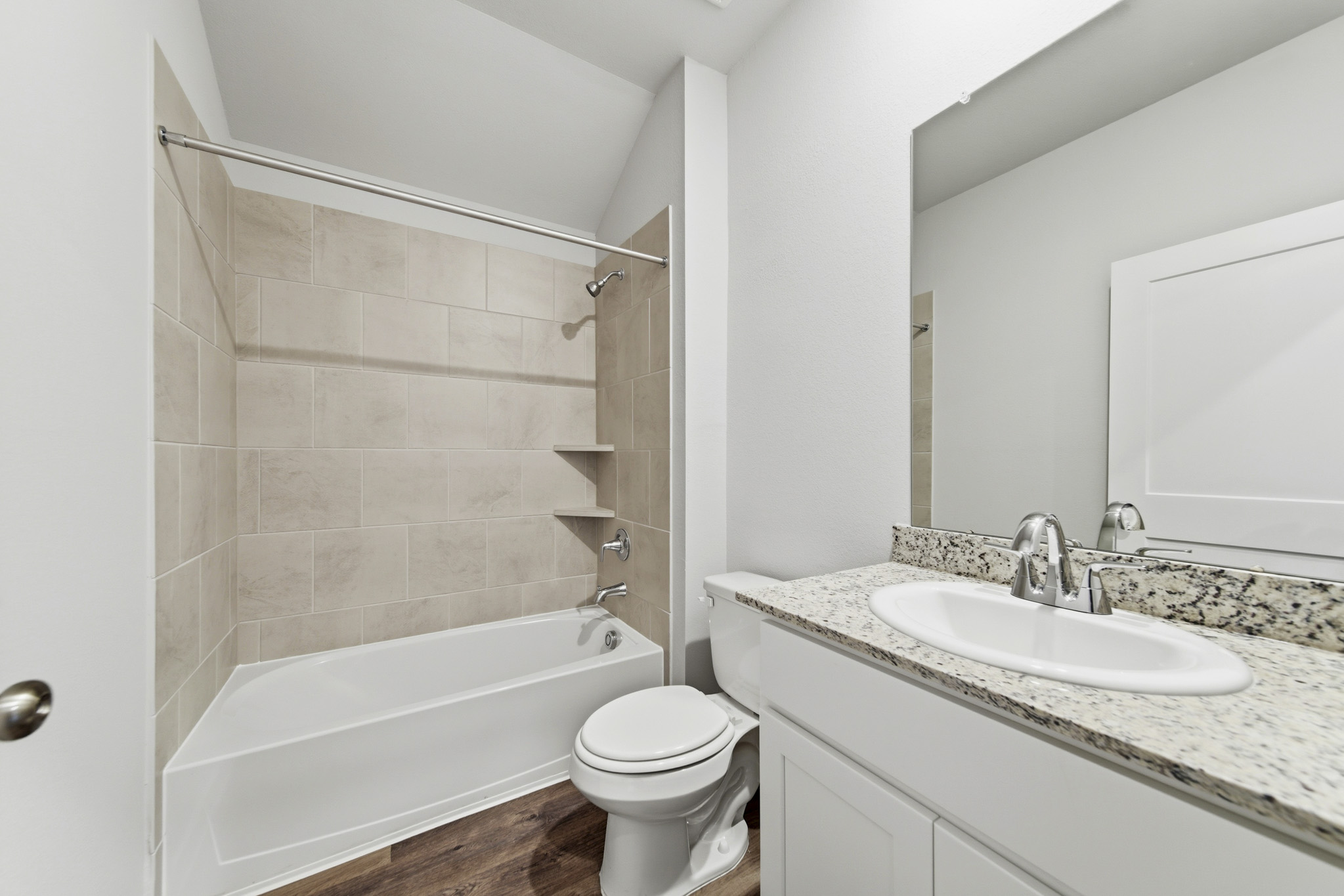 A bathroom with a tub sink and toilet.