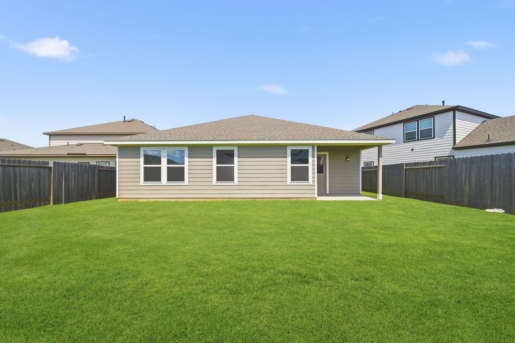 A house with a green lawn.