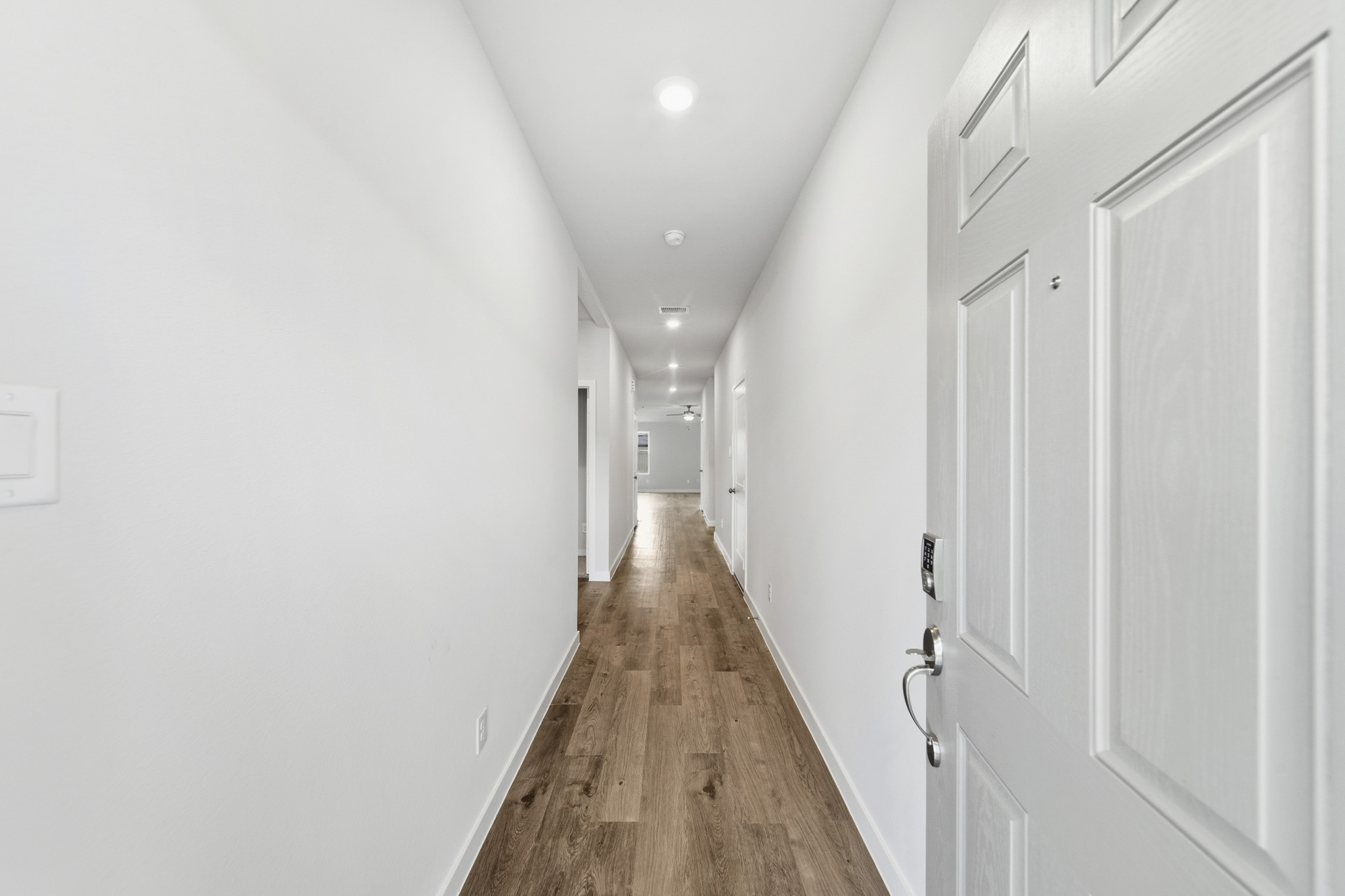 A hallway with white doors.