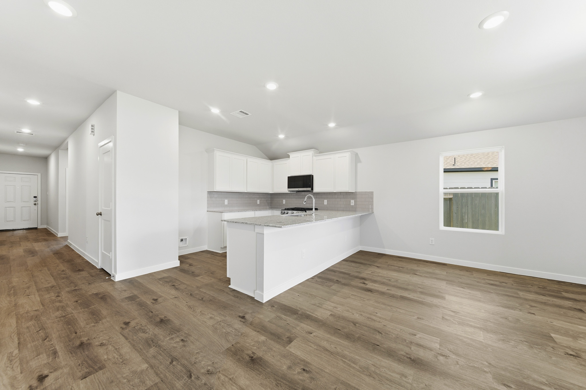 A kitchen with white cabinets.