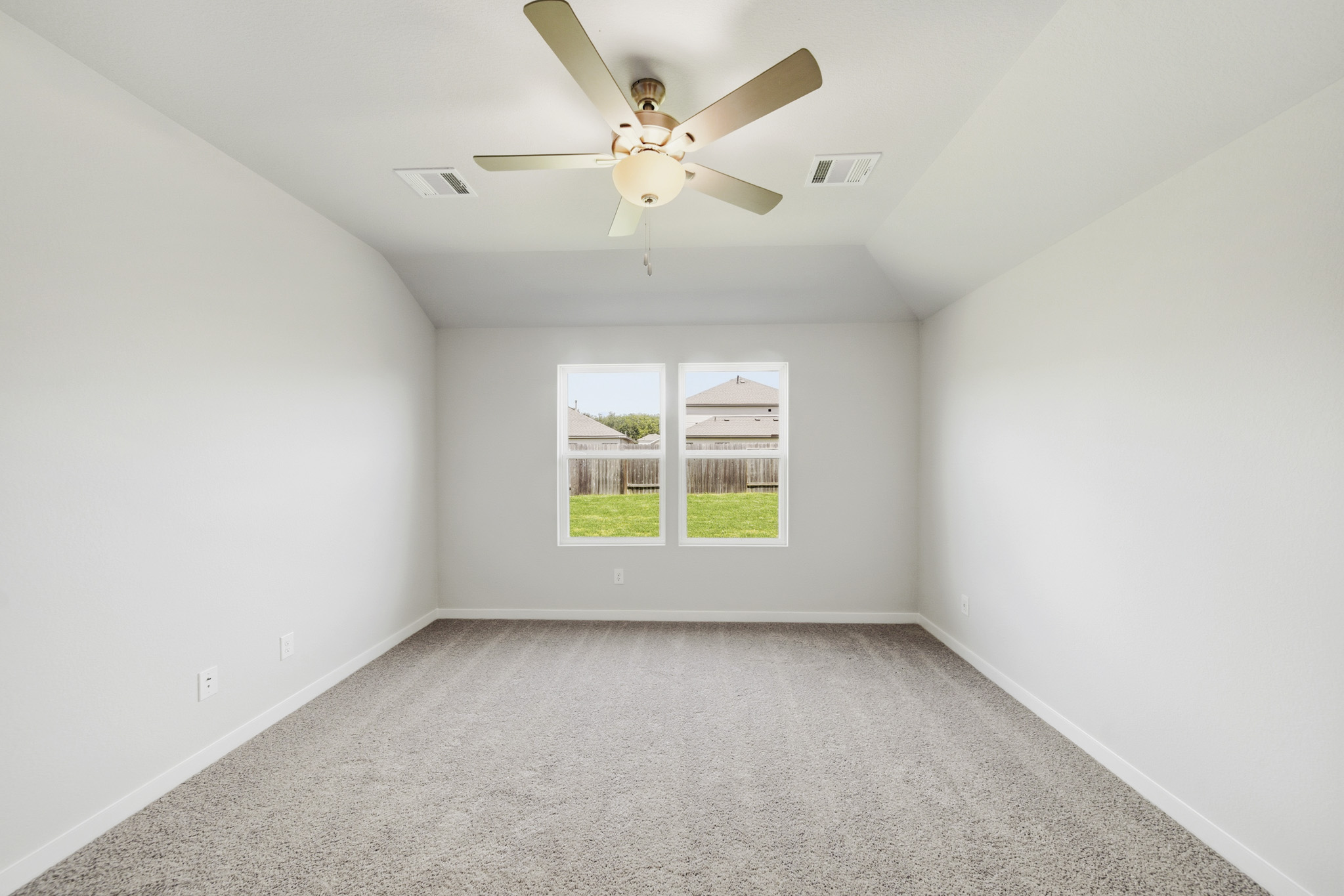 A room with a ceiling fan and a window.