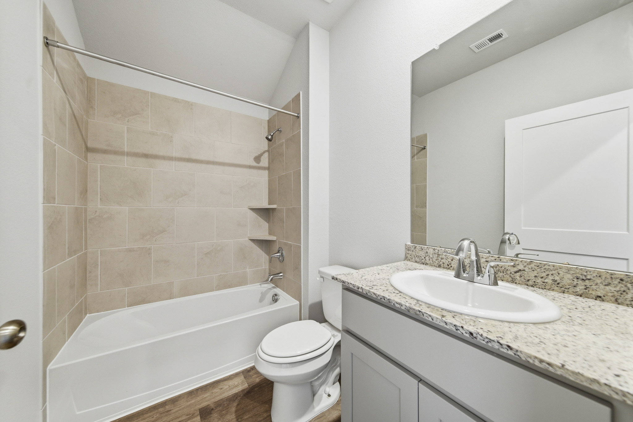 A bathroom with a tub sink and toilet.