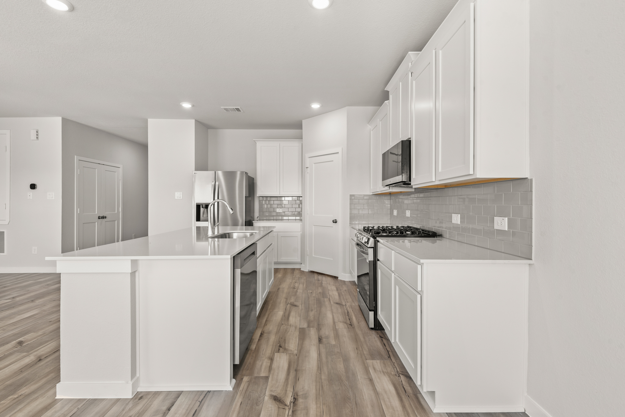 A kitchen with white cabinets.