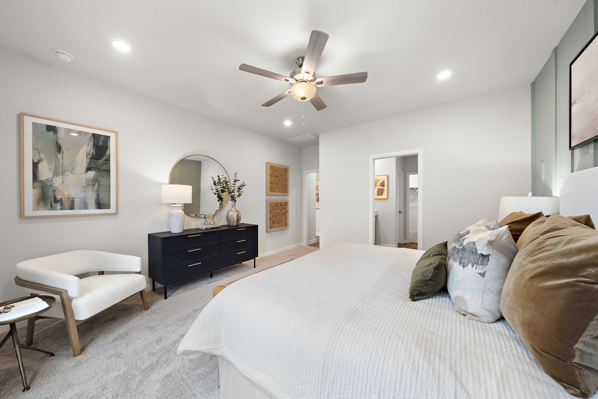 A bedroom with a bed and a fan.