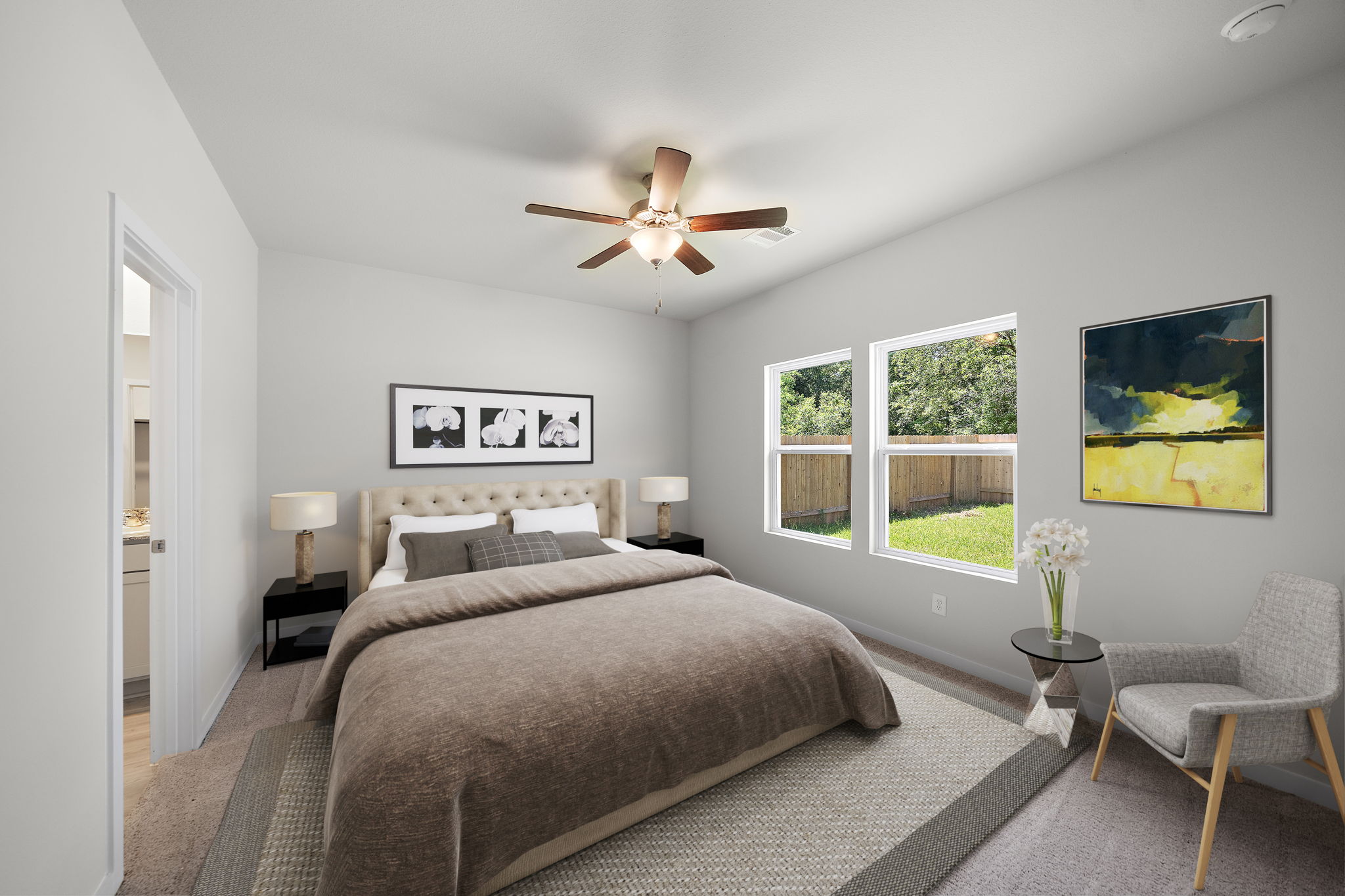 A bedroom with a bed and a fan.
