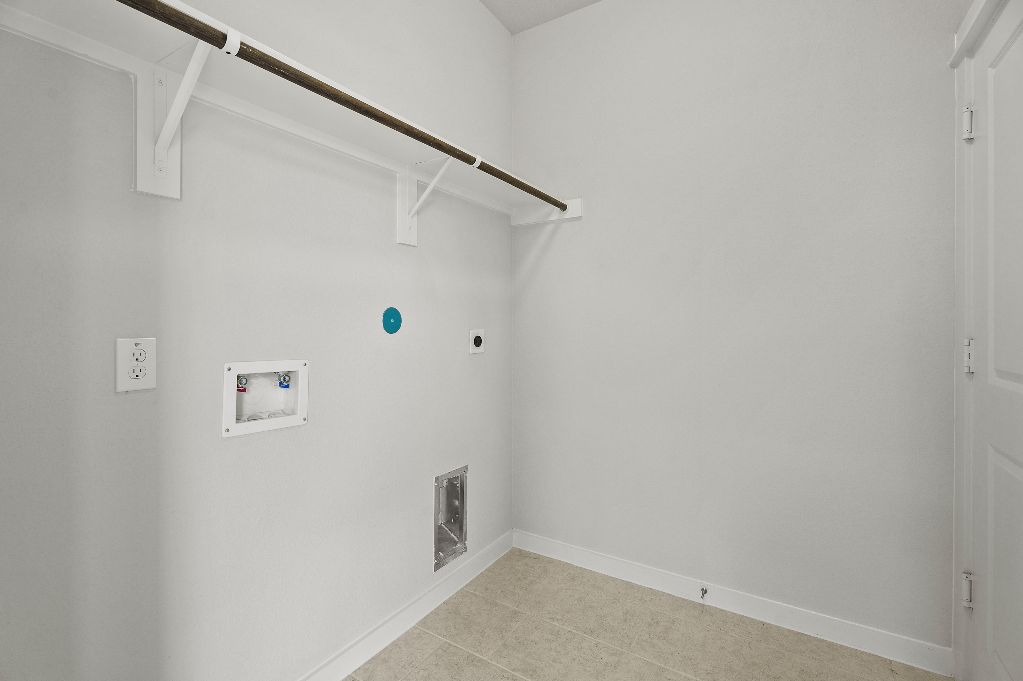 A white wall with a light fixture.