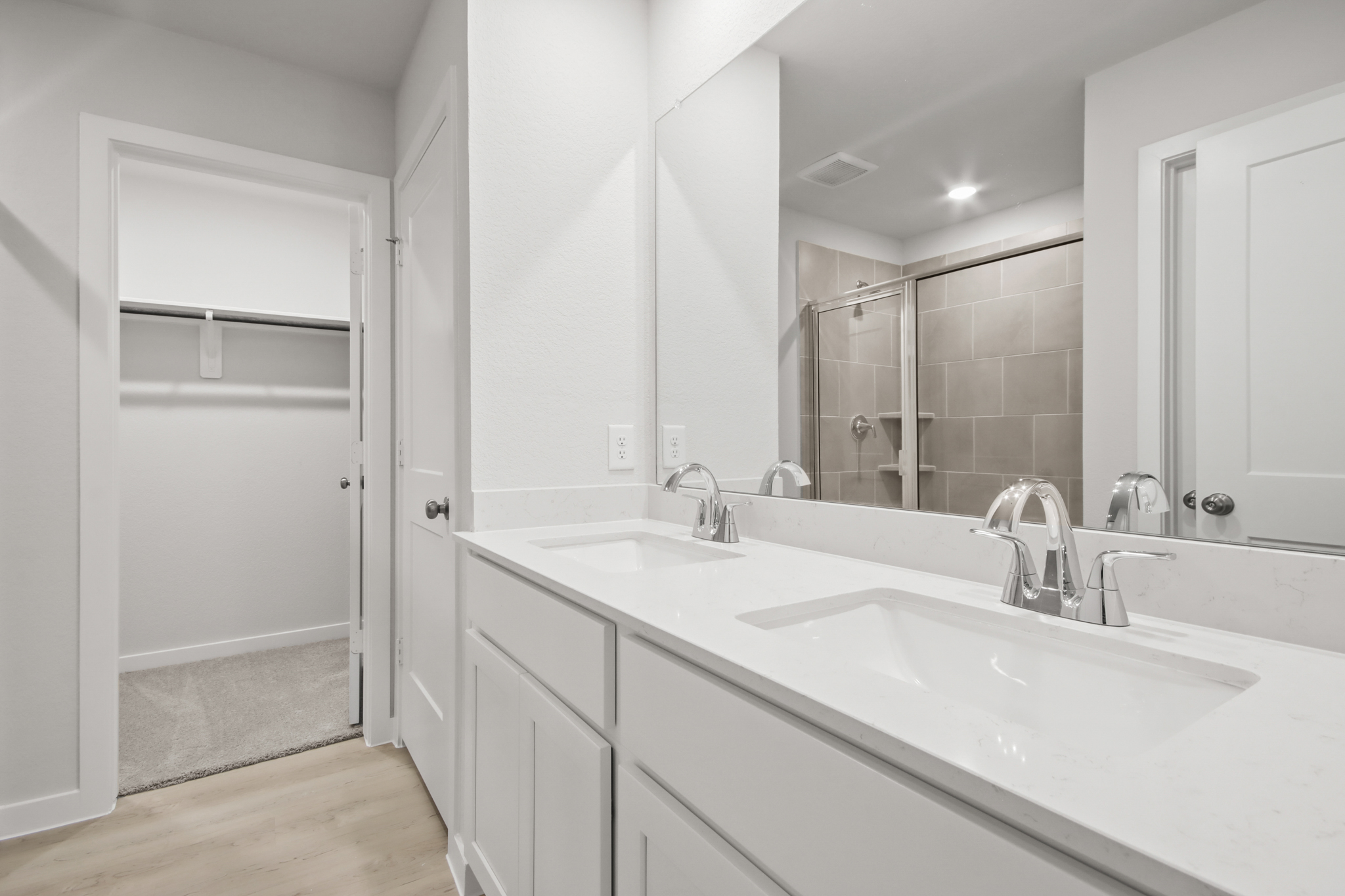 A bathroom with a large mirror.