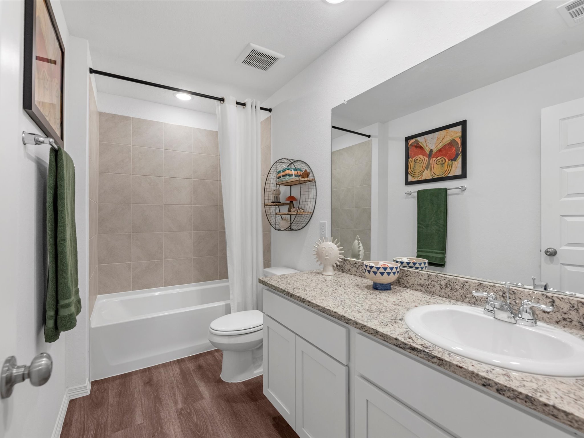 A bathroom with a sink toilet and a bathtub.