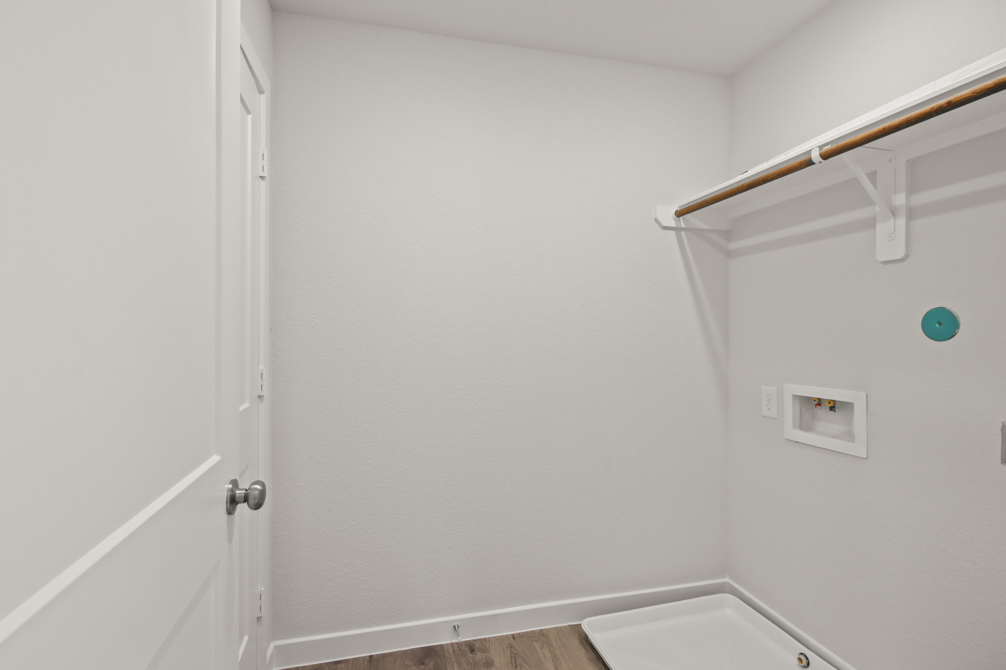 A white bathroom with a white door.