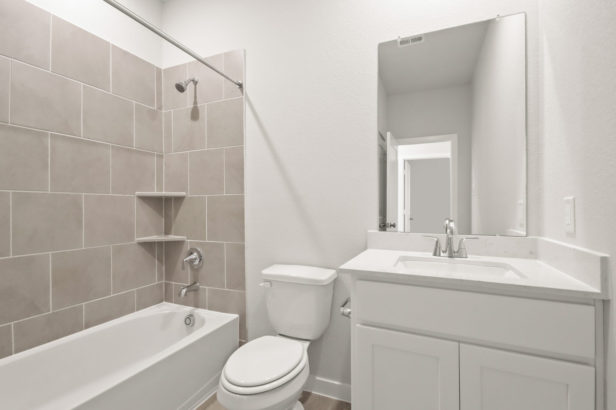 A bathroom with a tub sink and toilet.