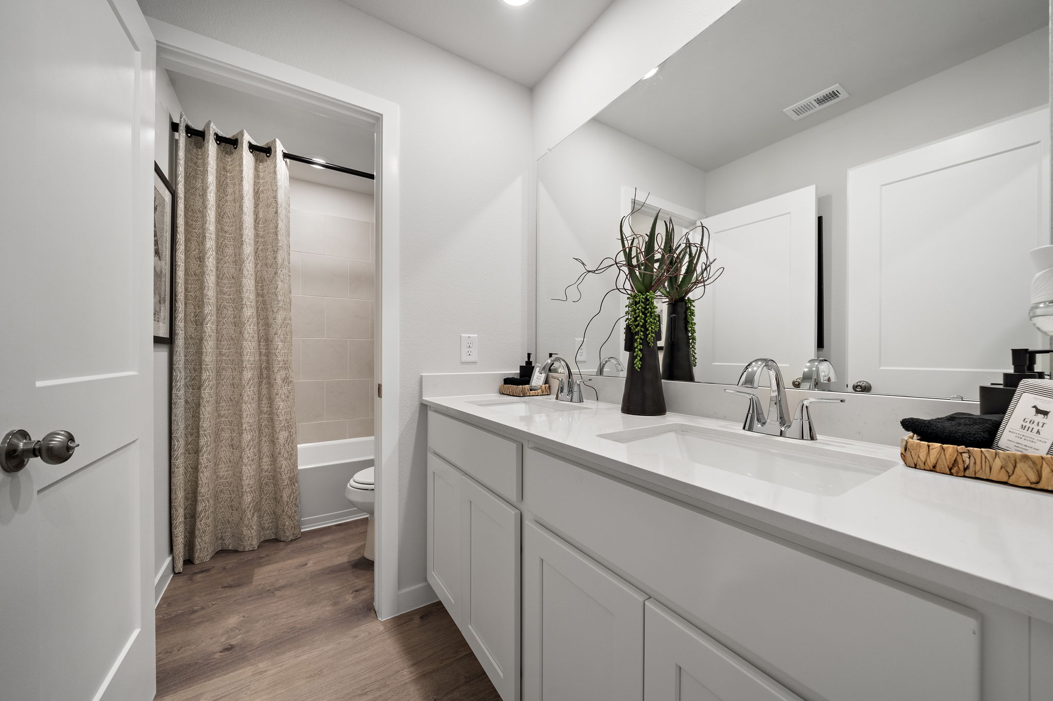 A bathroom with a tub sink and toilet.