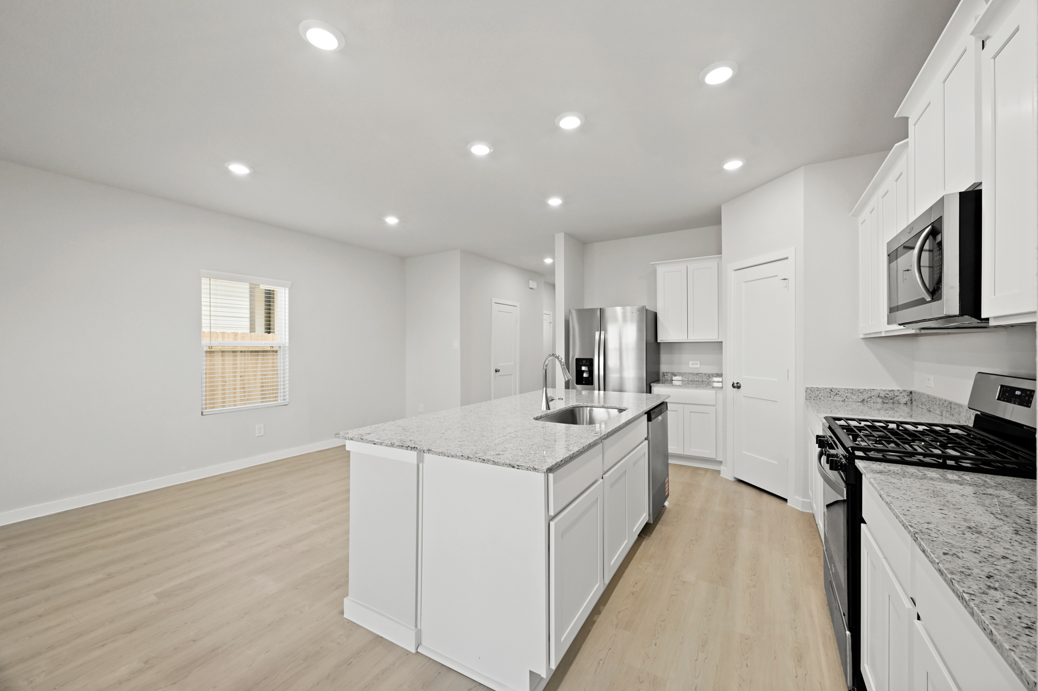 A kitchen with white cabinets.