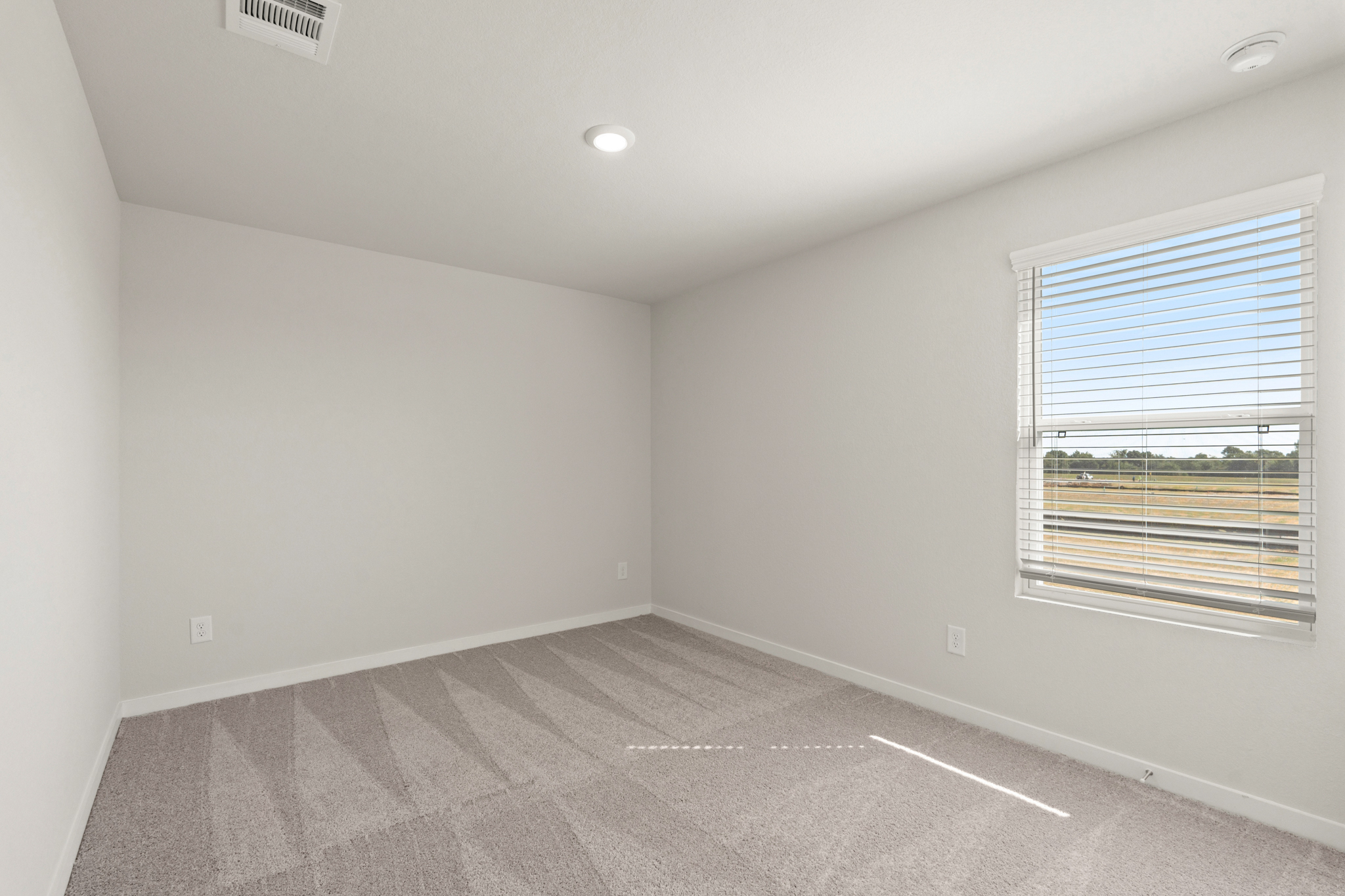 A room with a window and a tile floor.