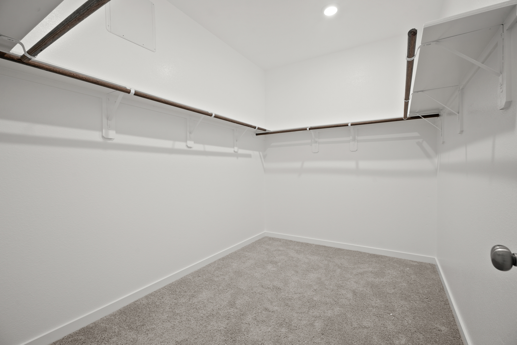 A white room with a carpet.