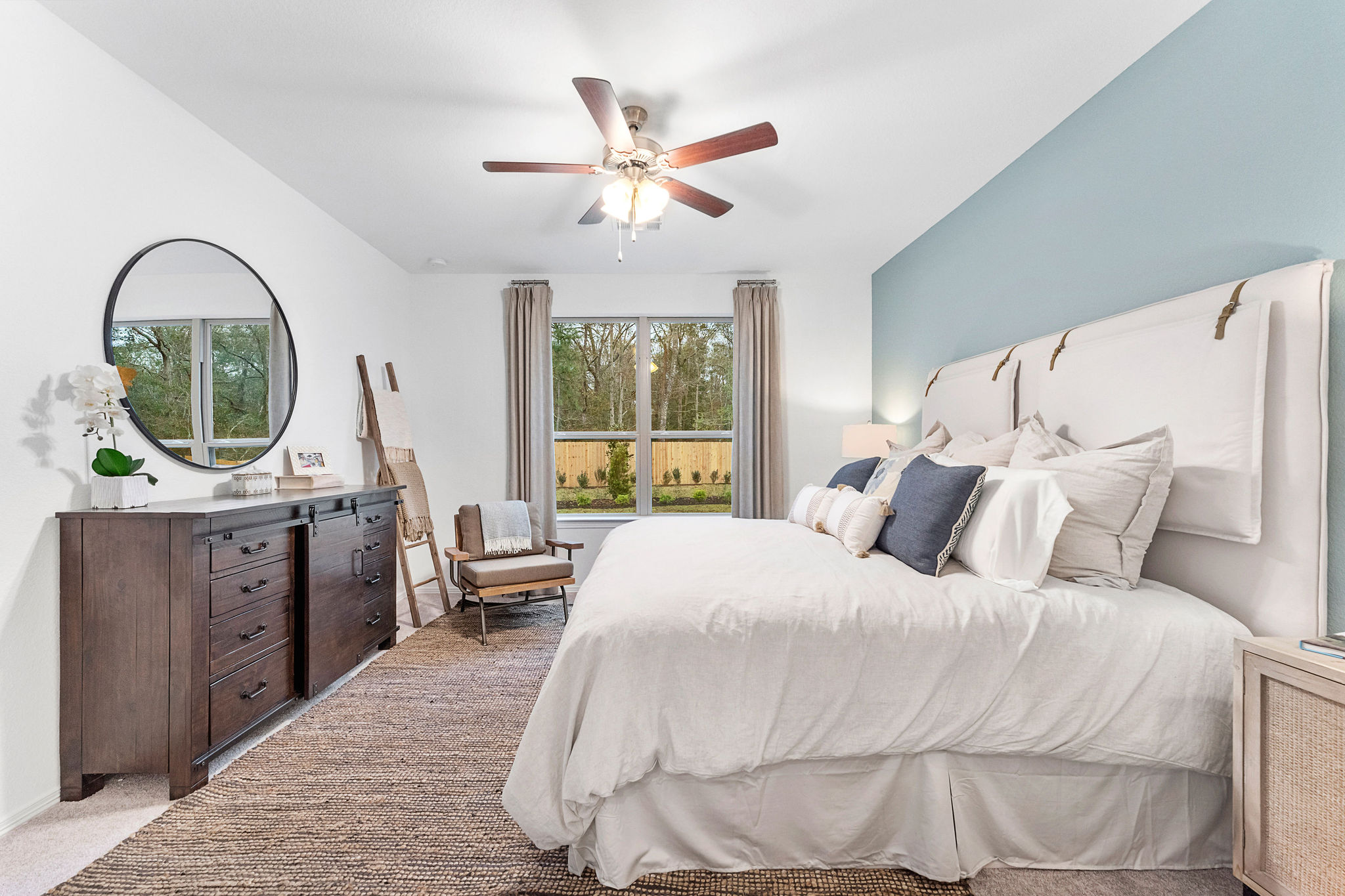 A bedroom with a bed and a fan.