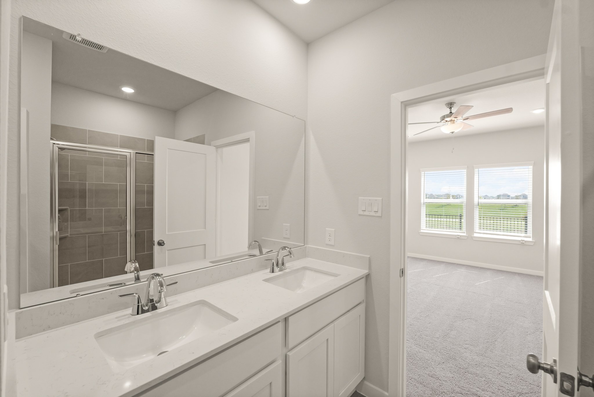 A bathroom with a large mirror.