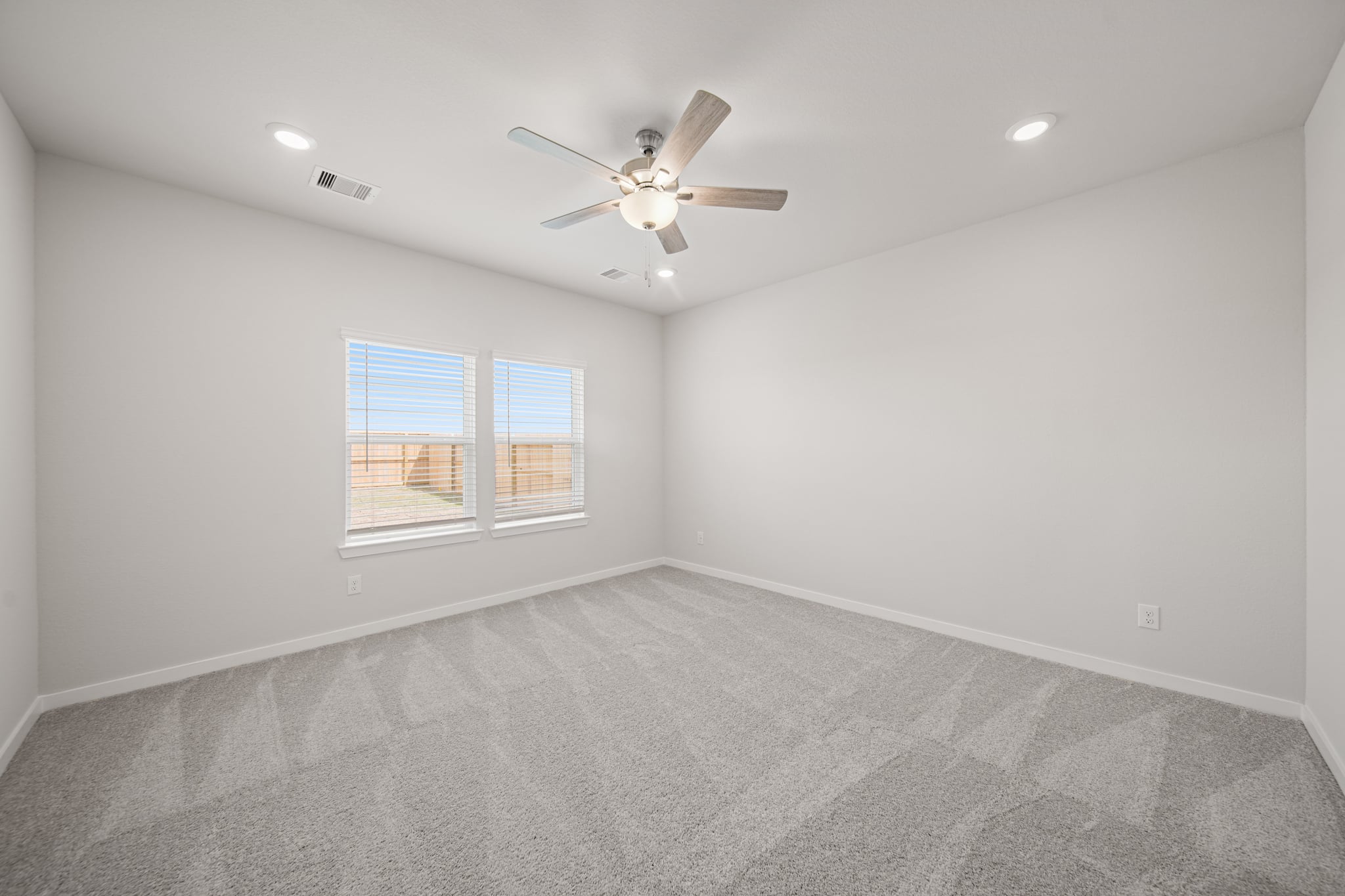 A room with a ceiling fan and a ceiling fan.