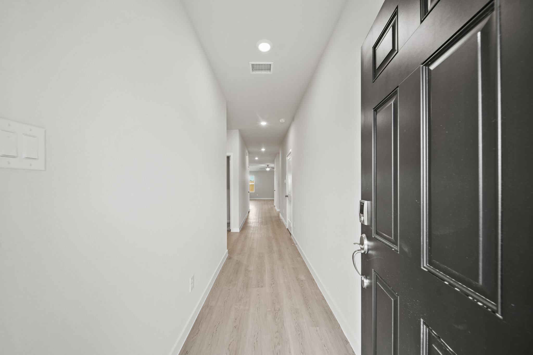 A hallway with black lockers.