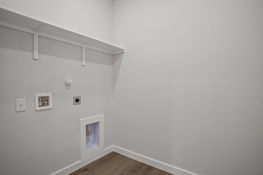 A white wall with pictures on it.