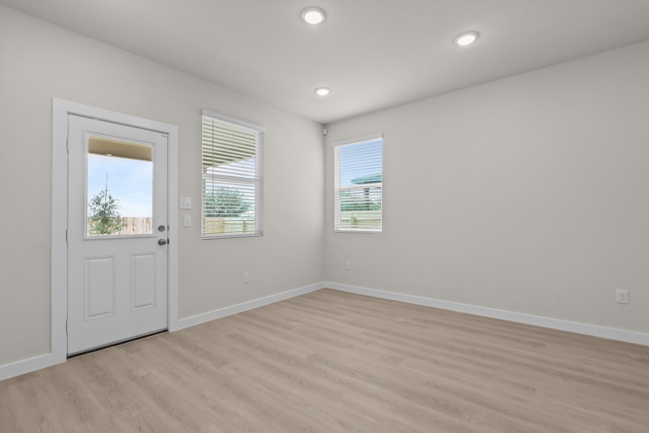 A room with white walls and a wood floor.