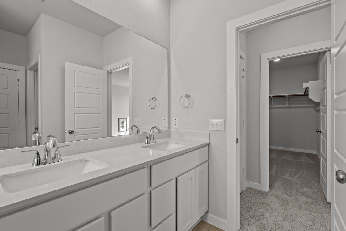 A bathroom with a large mirror.