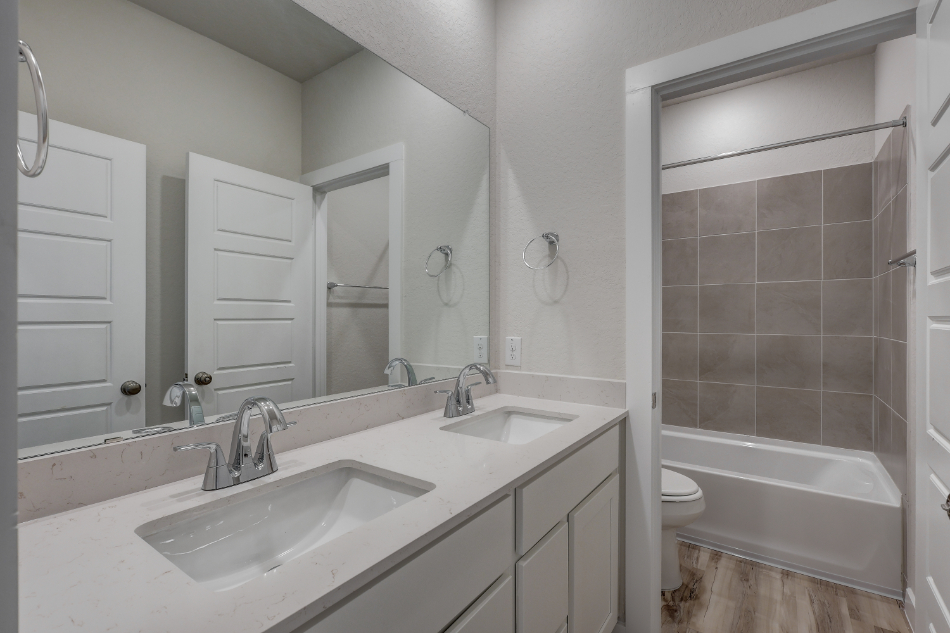 A bathroom with a tub sink and toilet.