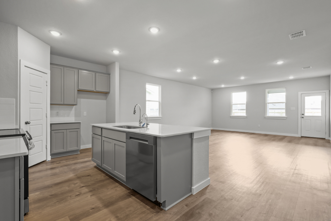 A kitchen with white cabinets.