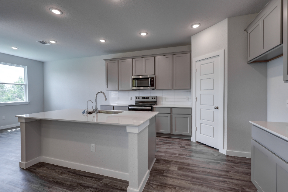 A kitchen with white cabinets.
