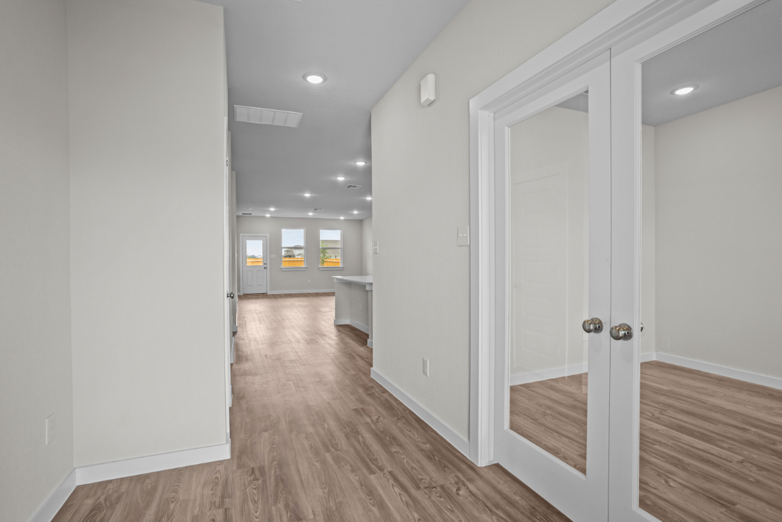 A hallway with white doors.